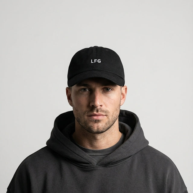 Man wearing a black cap with 'LFG' logo and a dark hoodie on a light gray background