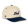 Dad Snapback Hat – Cream and navy snapback with 3D embroidered “Dad” logo. Structured five-panel hat and funny gift idea for dads from Dad Brand.